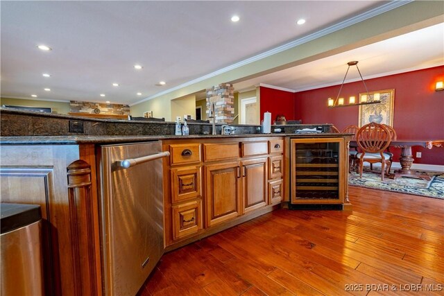 4956 Shorewood Dr, Osage Beach, MO 65065 - kitchen with stainless steel dishwasher, crown molding, dark wood-style floors, decorative light fixtures, and wine cooler