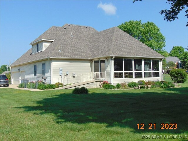 1932 Mimosa Ct, Lebanon, MO 65536 - back of house with a sunroom, a yard, and a shingled roof