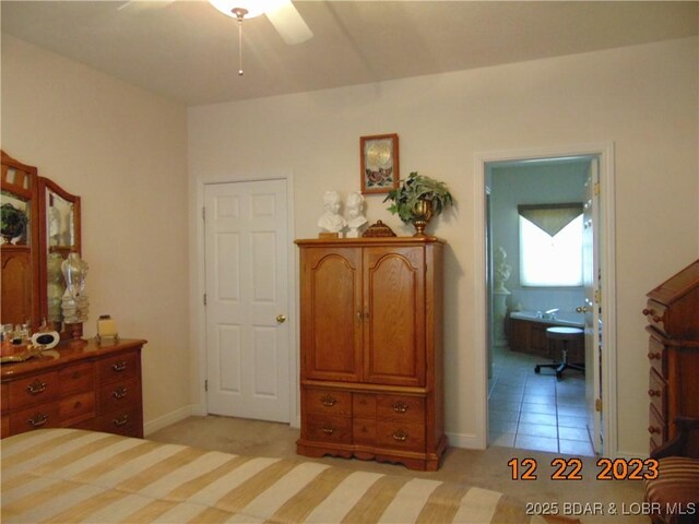 1932 Mimosa Ct, Lebanon, MO 65536 - bedroom with ensuite bath, light colored carpet, light tile patterned flooring, baseboards, and a ceiling fan