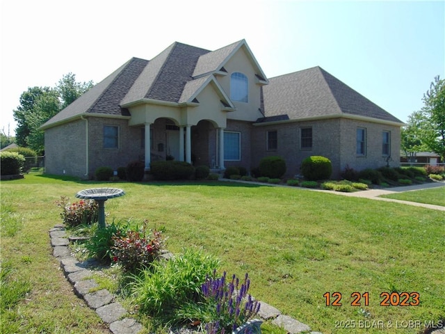 1932 Mimosa Ct, Lebanon, MO 65536 - view of front of property with brick siding, a front yard, and a shingled roof
