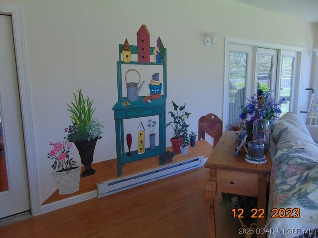 1932 Mimosa Ct, Lebanon, MO 65536 - living room with a baseboard heating unit and wood finished floors