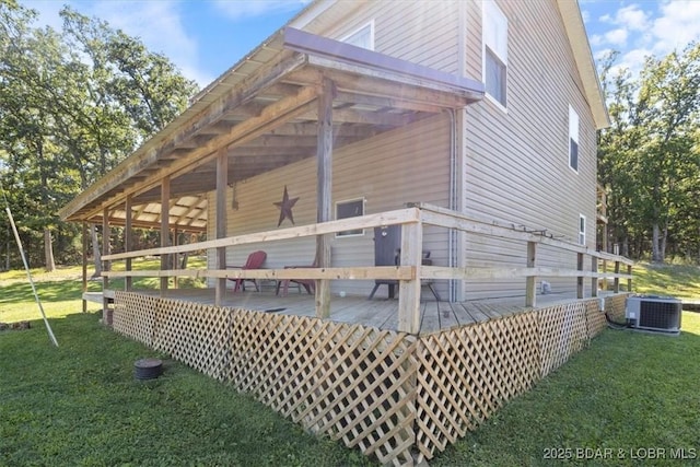 rear view of house featuring a deck, a lawn, and central air condition unit