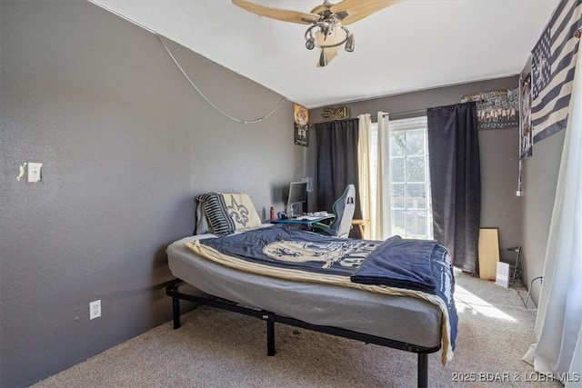 bedroom featuring baseboards, a ceiling fan, and carpet