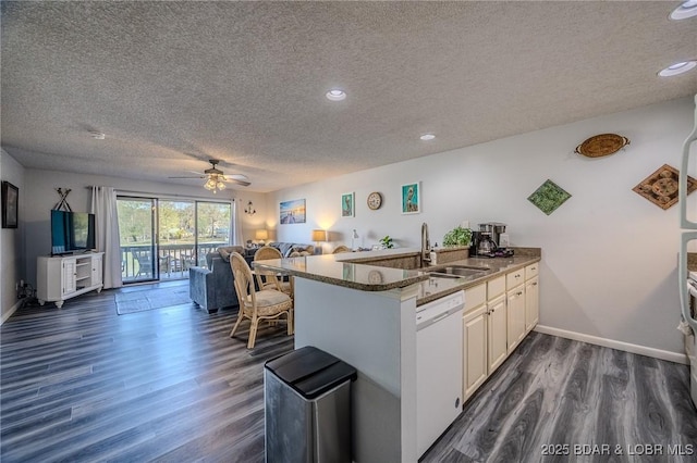 6570 Pelican Dr Unit 404, Osage Beach, MO 65065 - kitchen with a sink, dishwasher, a textured ceiling, open floor plan, and dark wood-type flooring