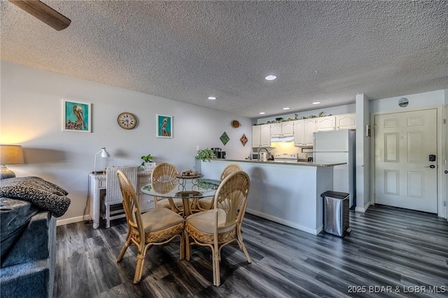 6570 Pelican Dr Unit 404, Osage Beach, MO 65065 - dining area with dark wood-style floors, recessed lighting, a textured ceiling, and baseboards