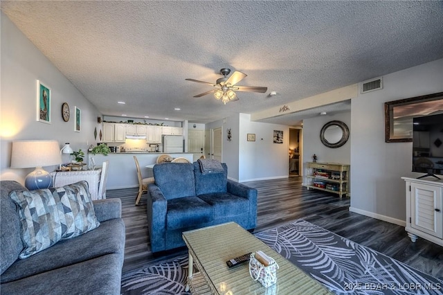 6570 Pelican Dr Unit 404, Osage Beach, MO 65065 - living area with dark wood finished floors, a ceiling fan, baseboards, and a textured ceiling