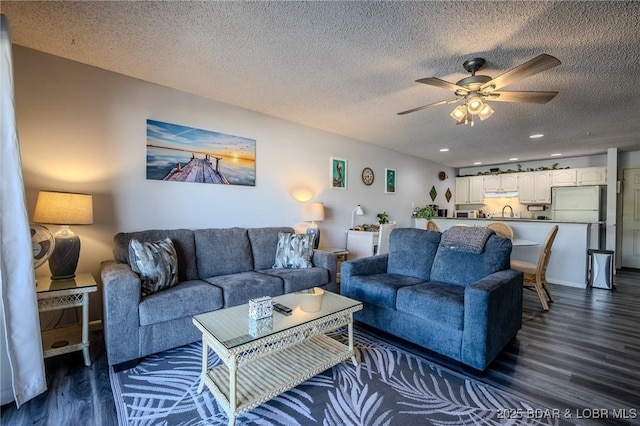 6570 Pelican Dr Unit 404, Osage Beach, MO 65065 - living room featuring dark wood-style flooring, ceiling fan, a textured ceiling, and recessed lighting