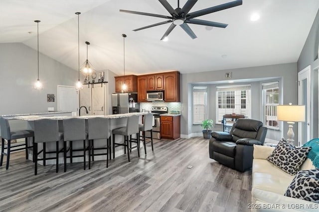 5177 Vicus Castry, Osage Beach, MO 65065 - living room with light wood-style flooring, recessed lighting, baseboards, ceiling fan, and high vaulted ceiling