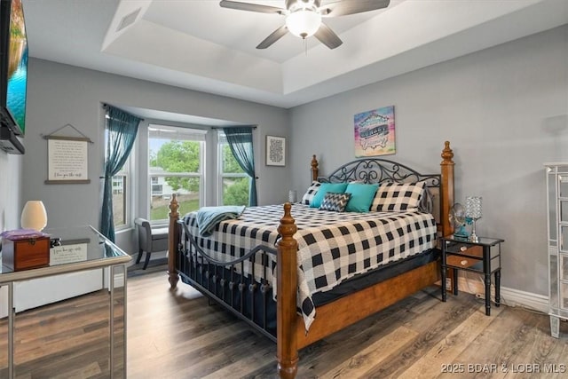 5177 Vicus Castry, Osage Beach, MO 65065 - bedroom featuring a raised ceiling, ceiling fan, visible vents, and wood finished floors