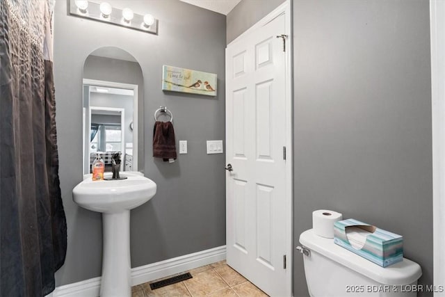 5177 Vicus Castry, Osage Beach, MO 65065 - bathroom with toilet, baseboards, visible vents, a sink, and tile patterned floors