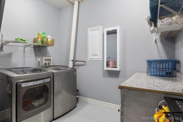 5177 Vicus Castry, Osage Beach, MO 65065 - laundry room featuring baseboards, laundry area, and separate washer and dryer