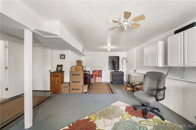 9 Gage Rd, Eldon, MO 65026 - interior space with visible vents, a wood stove, ceiling fan, and a textured ceiling
