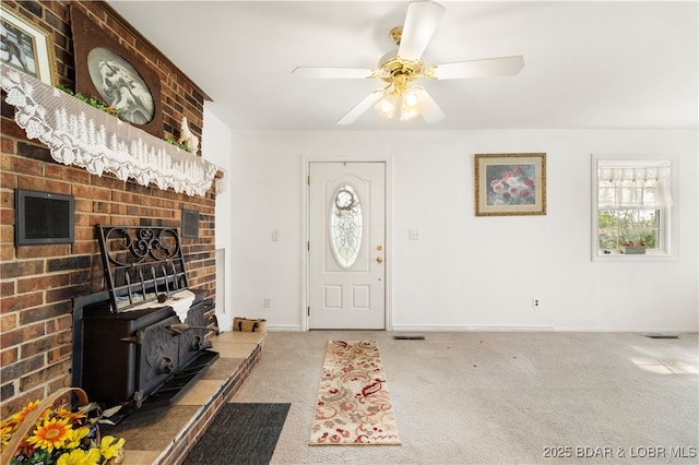9 Gage Rd, Eldon, MO 65026 - carpeted foyer with baseboards, a wood stove, a wealth of natural light, and ceiling fan