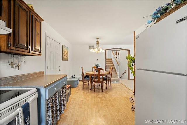 9 Gage Rd, Eldon, MO 65026 - dining area featuring an inviting chandelier, stairway, visible vents, and light wood-style flooring