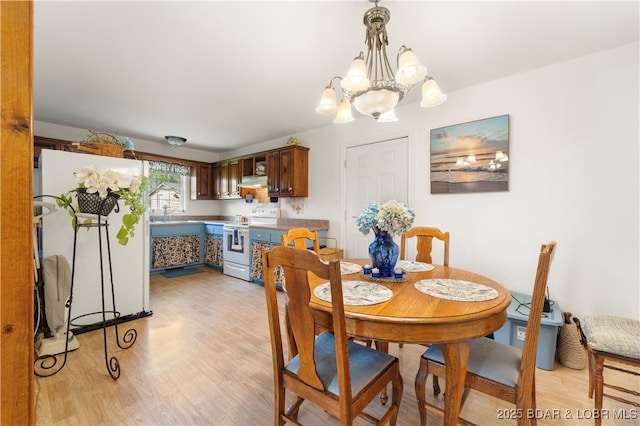 9 Gage Rd, Eldon, MO 65026 - dining room with a notable chandelier and light wood finished floors