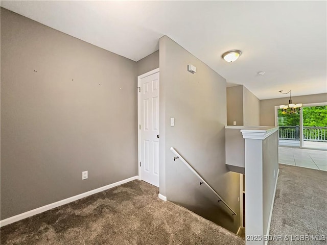 stairs featuring carpet flooring and baseboards