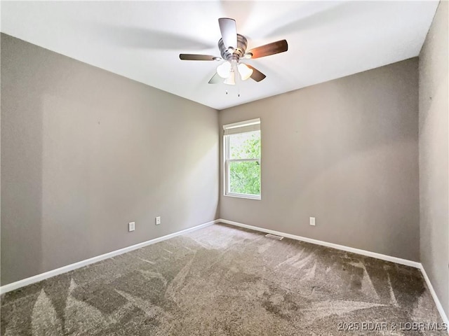 carpeted empty room with visible vents, ceiling fan, and baseboards