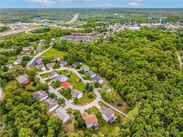 birds eye view of property featuring a residential view and a forest view