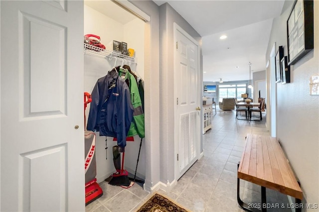 hall featuring baseboards and tile patterned flooring