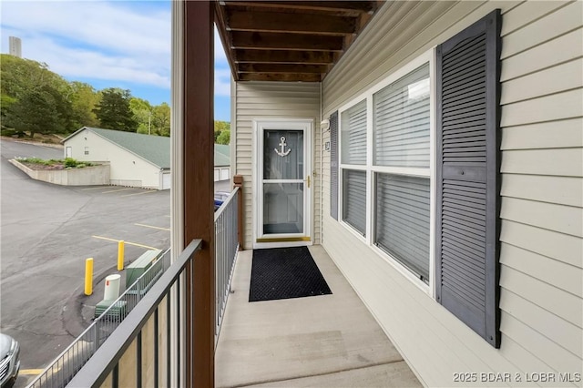 view of exterior entry with a balcony