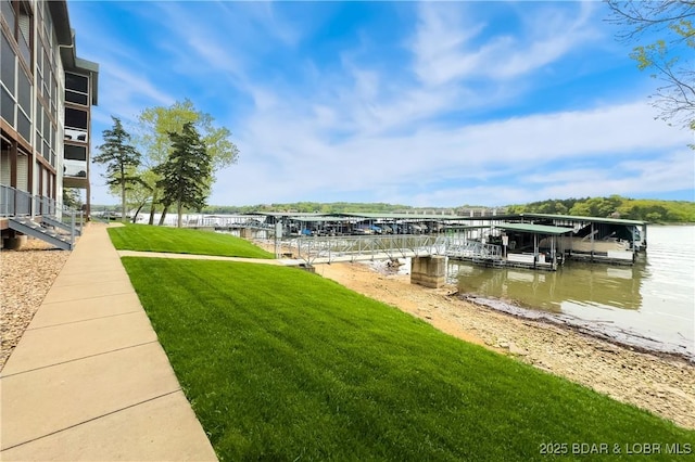 dock area with a yard, a water view, and boat lift