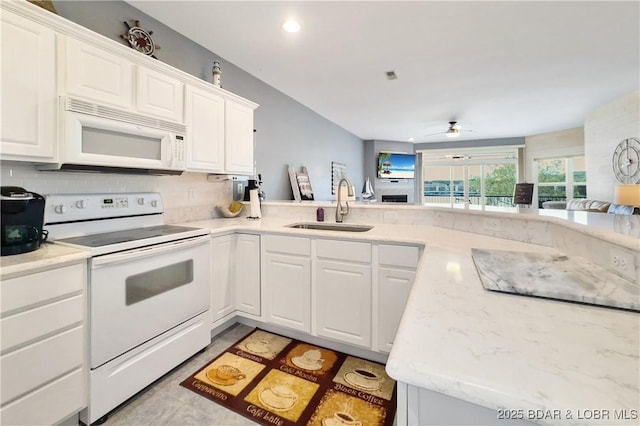 kitchen with white cabinetry, a sink, visible vents, white appliances, and a ceiling fan
