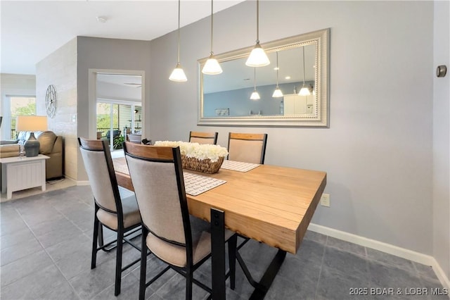 dining room featuring baseboards and tile patterned floors