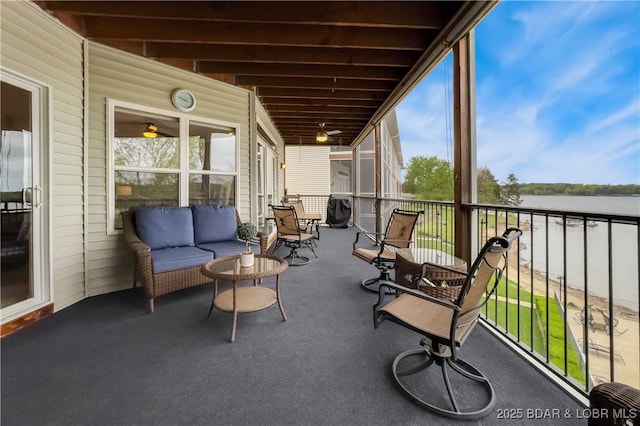 sunroom / solarium featuring a water view and outdoor lounge area