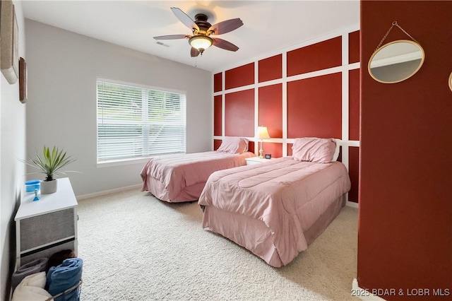 bedroom featuring visible vents, baseboards, a ceiling fan, and light carpet