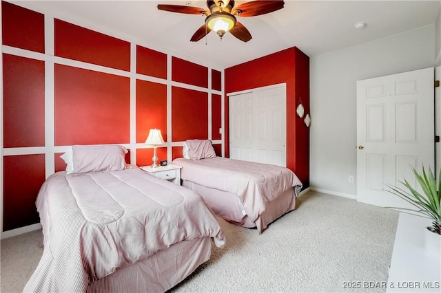 bedroom featuring baseboards, ceiling fan, carpet floors, and a closet