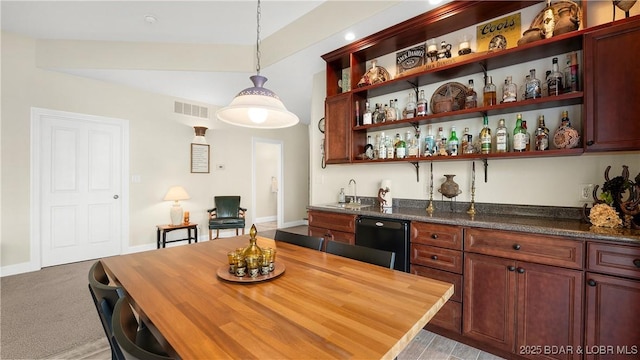 bar featuring a sink, black dishwasher, wet bar, visible vents, and pendant lighting