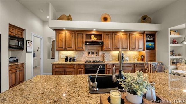 kitchen with black microwave, tasteful backsplash, open shelves, stainless steel gas stovetop, and oven