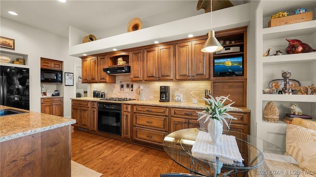 kitchen with brown cabinets, open shelves, recessed lighting, decorative light fixtures, and black appliances