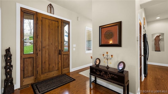 entrance foyer with baseboards, dark wood-style floors, and visible vents