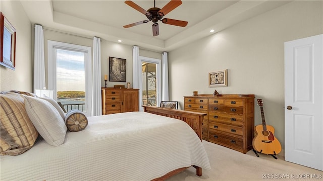 bedroom featuring a raised ceiling, light carpet, a ceiling fan, and recessed lighting