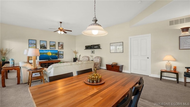 carpeted dining room featuring ceiling fan, visible vents, and baseboards