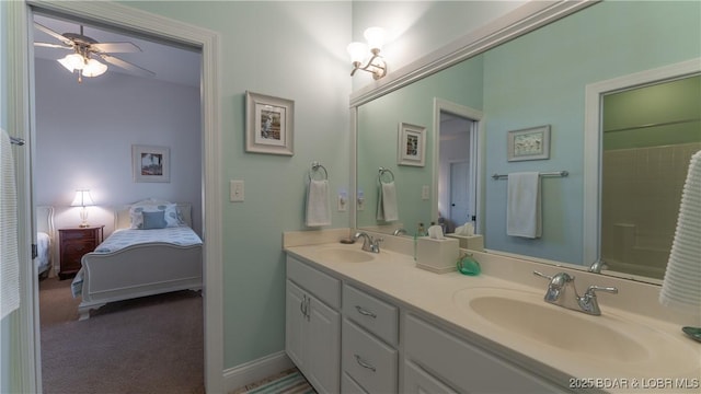 ensuite bathroom featuring double vanity, a sink, a ceiling fan, and ensuite bathroom