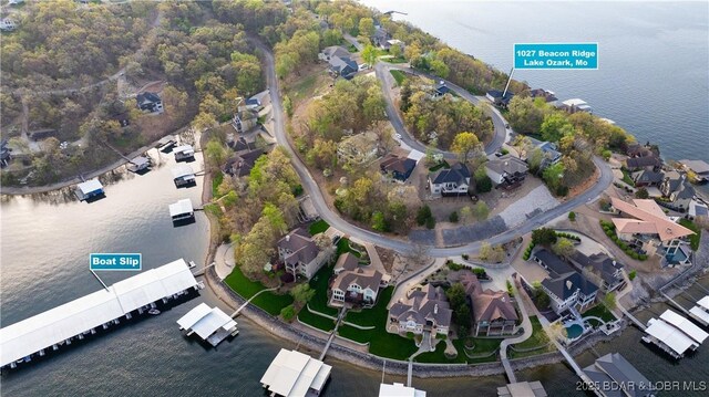 drone / aerial view featuring a water view and a residential view