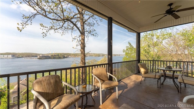 sunroom / solarium featuring a healthy amount of sunlight and a water view