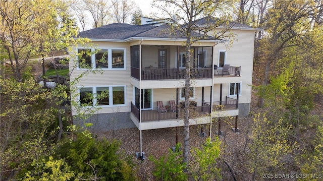 rear view of property with a balcony