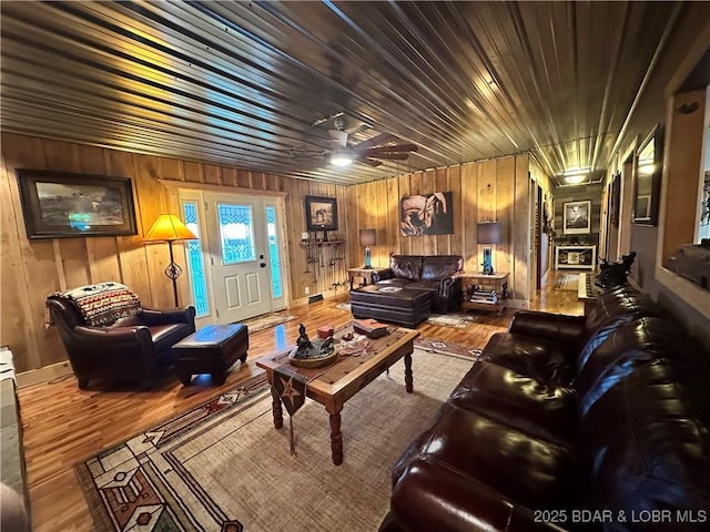 69985 US Highway 50, Tipton, MO 65081 - living area featuring wood finished floors, wooden walls, and ceiling fan