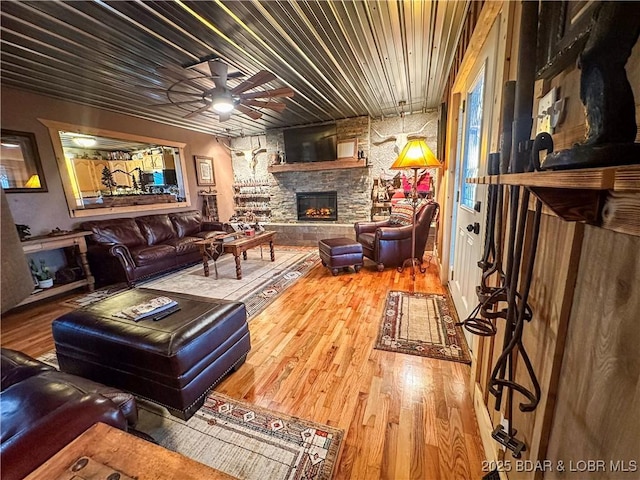 69985 US Highway 50, Tipton, MO 65081 - living room featuring a fireplace, wood finished floors, and ceiling fan
