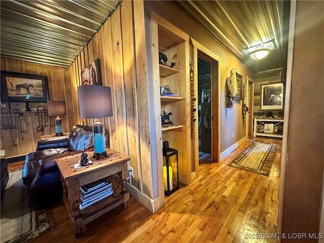 69985 US Highway 50, Tipton, MO 65081 - hallway with light wood-type flooring, wooden walls, and built in features