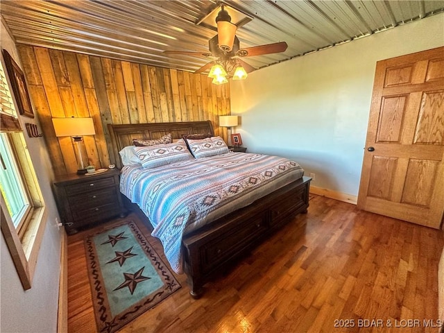 69985 US Highway 50, Tipton, MO 65081 - bedroom with wood finished floors, wood walls, and ceiling fan