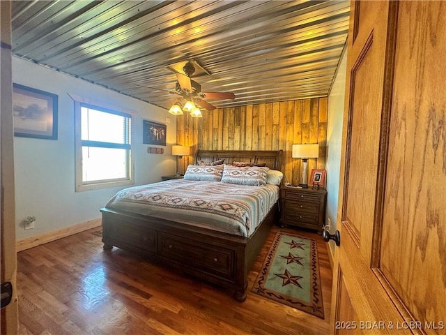 69985 US Highway 50, Tipton, MO 65081 - bedroom featuring wood finished floors, ceiling fan, baseboards, wooden ceiling, and wood walls