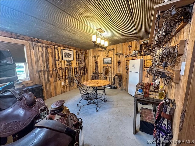 69985 US Highway 50, Tipton, MO 65081 - dining space with wood walls and unfinished concrete flooring