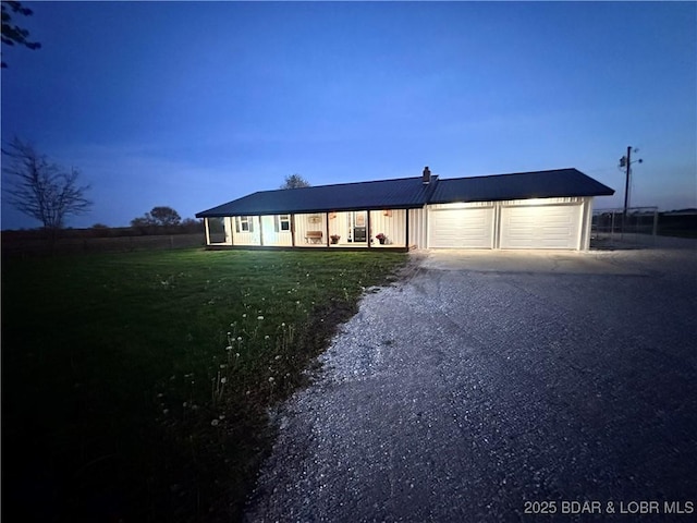 69985 US Highway 50, Tipton, MO 65081 - ranch-style home with a garage, a front lawn, driveway, and covered porch