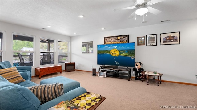 carpeted living room featuring baseboards, visible vents, a ceiling fan, and recessed lighting