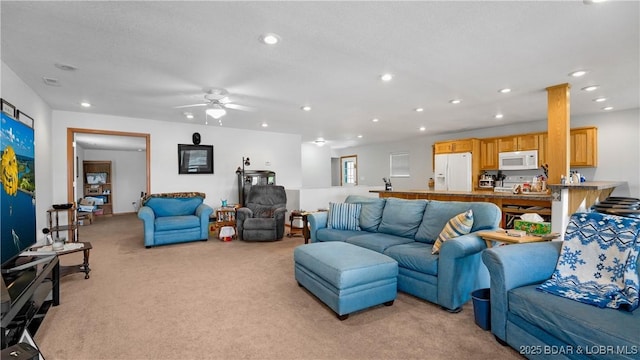 living room featuring recessed lighting, a ceiling fan, and light carpet