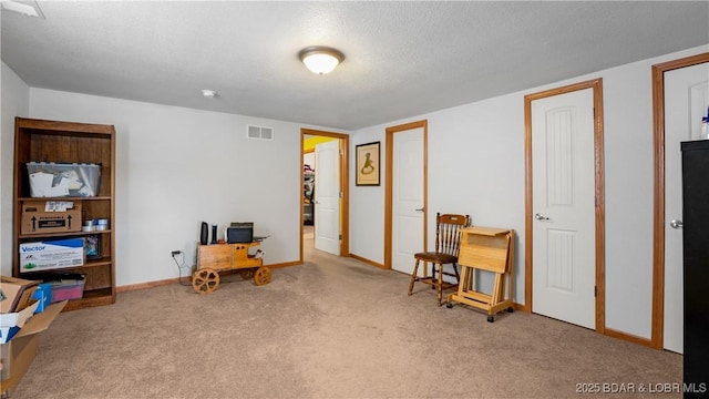 interior space with visible vents, carpet, and baseboards
